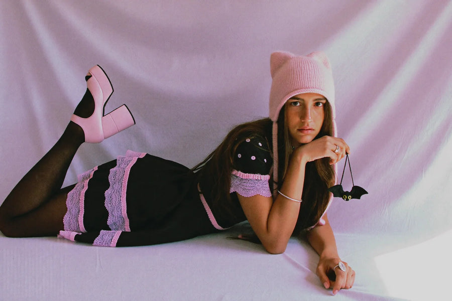 Kawaii goth outfit with a black babydoll dress, pink lace trim, cat ear beanie and chunky platform Mary Janes